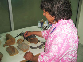 Beverly Perkins works on the restoration of artifacts.